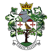 A coat of arms featuring a crowned helmet, green foliage, and a shield with a tree and bird, flanked by two crosses. The motto ribbon below reads "Vincit Veritas.