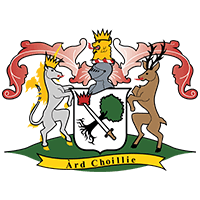 Illustration of a coat of arms featuring a unicorn and a stag flanking a shield with a tree and crown. A knight's helmet with plume sits on top, and a banner below reads "Ard Choillie.