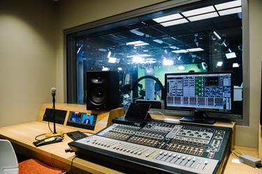 A sound-proof room with radio, sound board and microphone equipment at UniSQ Springfield.