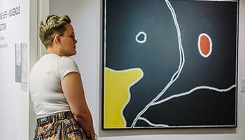 Lady looking at a painting.