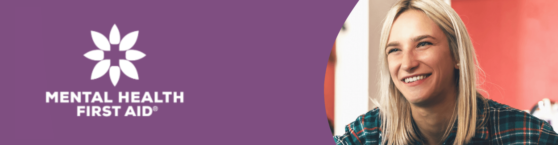 A woman smiling sits next to a purple panel displaying the Mental Health First Aid logo and text.