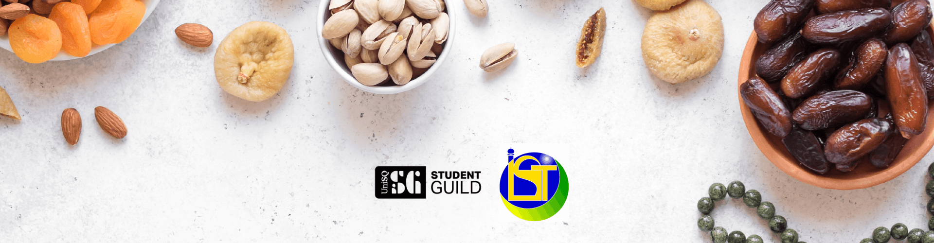 Bowls of dried fruit, nuts, and dates on a white surface with the Student Guild and IST logos in the center.