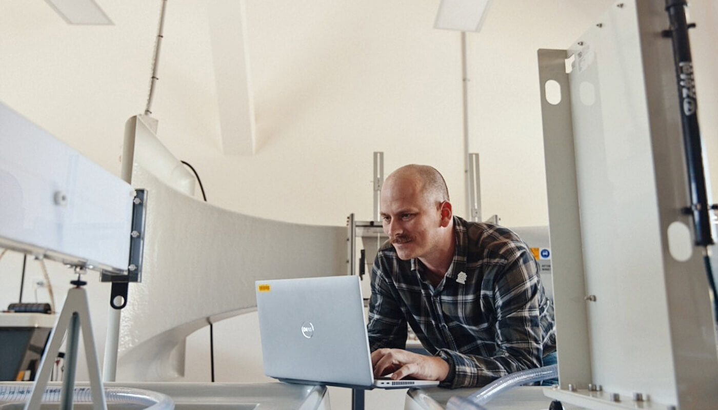 A man sitting at a desk with a laptop.