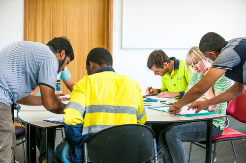 Group of people engaged in a collaborative activity at a table