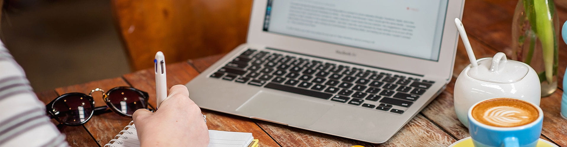 student at desk writing in a notebook