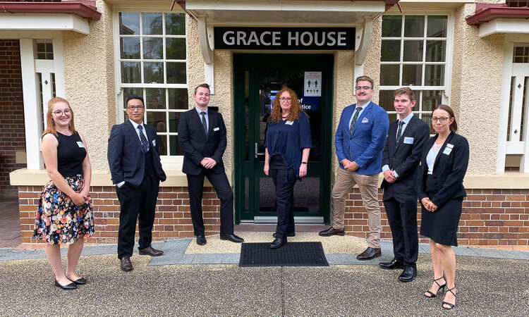 Law Society members stand outside Grace House.