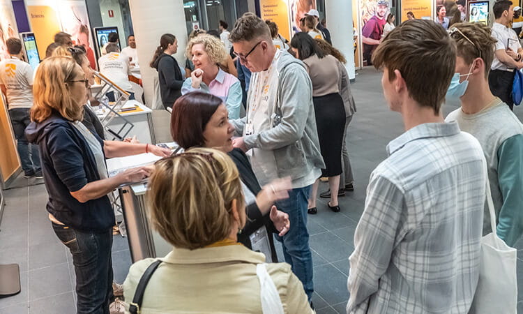 UniSQ staff speaking with prospective students at UniSQ Springfield.