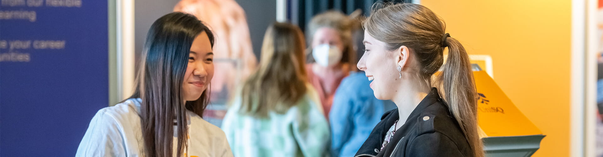 Female UniSQ staff member speaking with a female prospective student.