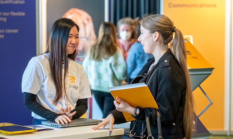 A female UniSQ staff member speaking with a female prospective student. 
