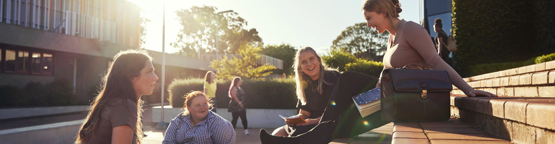  Student representatives sitting outside laughing together