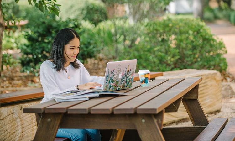 A girl studying outside. 