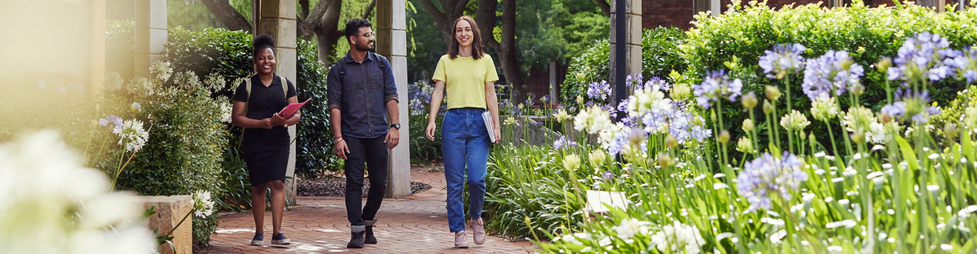 Three people walking on a path.