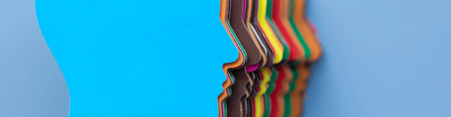 A stack of multicolored paper sheets with wavy edges, arranged vertically against a blue background.