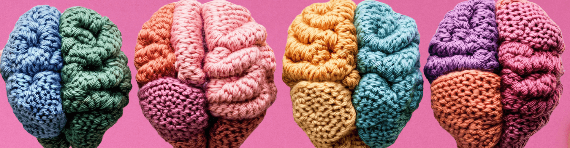 Four colorful crocheted brains are displayed side by side against a pink background, each with distinct color combinations representing brain hemispheres.