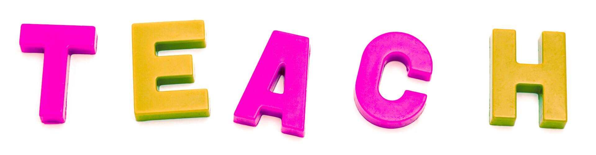 Plastic magnetic letters spelling the word "TEACH" on a white background; letters are pink and yellow.