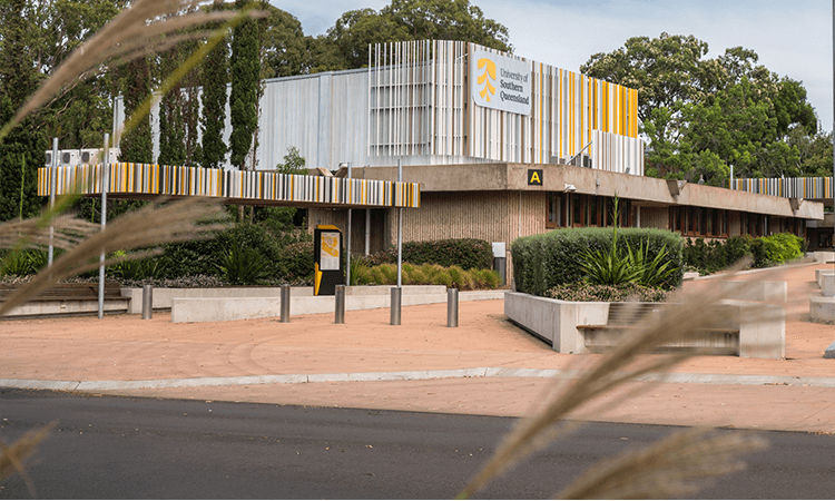 UniSQ Toowomba's landscaped entrance and logo on facade.