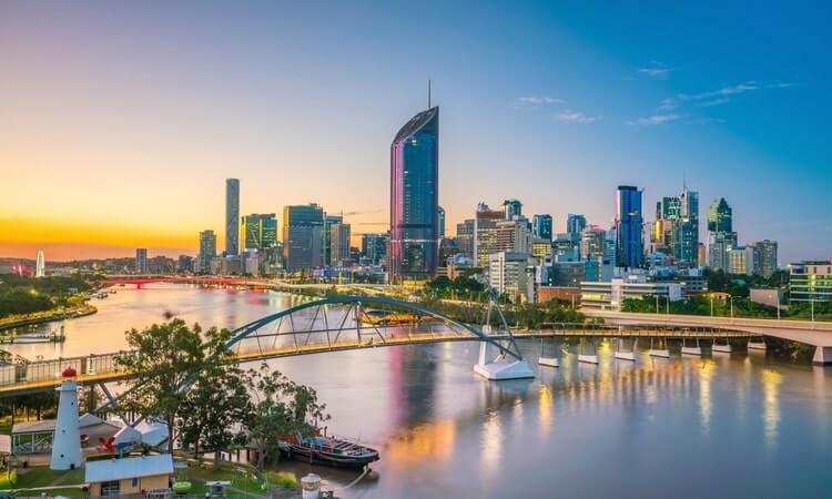 Brisbane skyline at dusk with the Goodwill Bridge in the foreground.