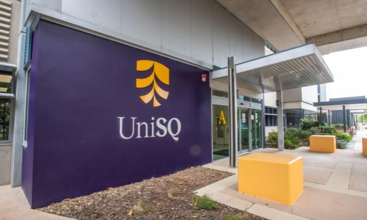 University of Southern Queensland (UniSQ) Springfield entrance with logo and colourful sitting cubes.