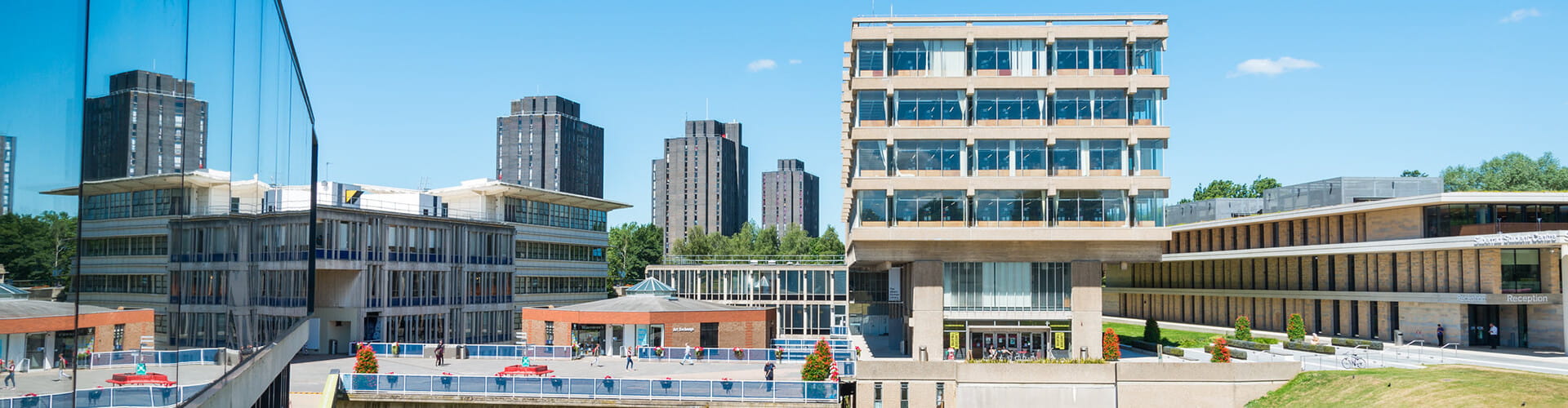 Modern university campus with brutalist architecture on a clear day.