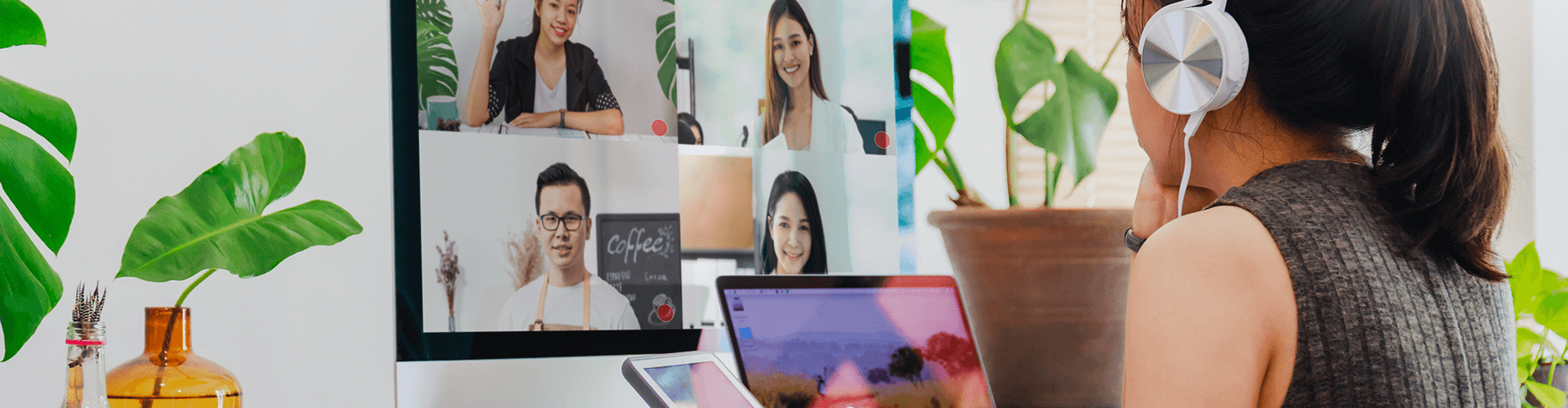 Woman participates in a video conference from a home office environment.