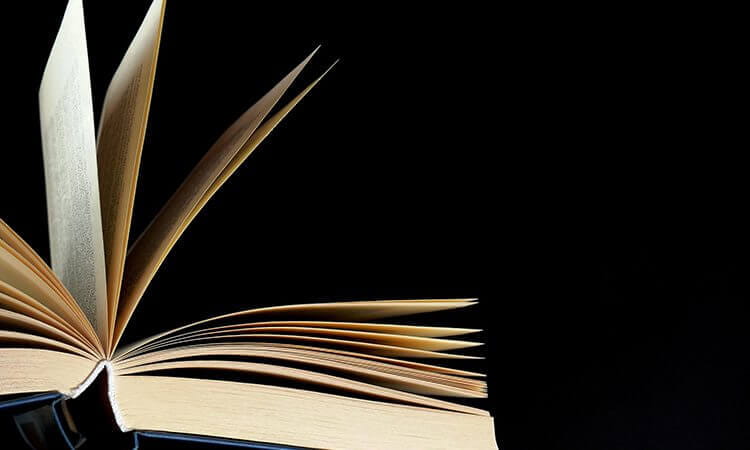 An open book against a black background