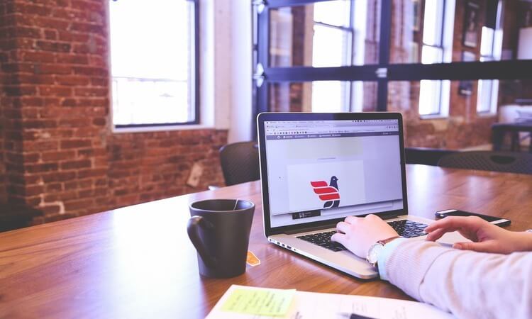 Student studying on a laptop with coffee