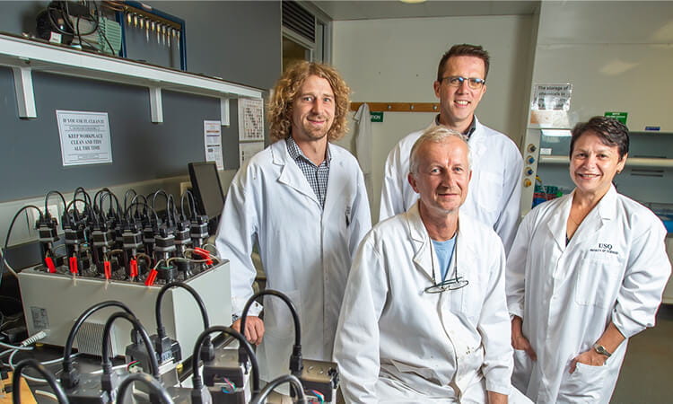 Four UniSQ researchers in a lab