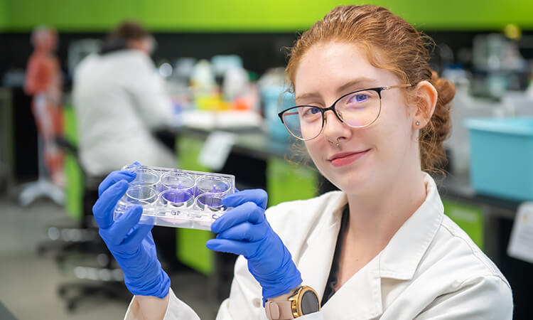 Third-year Biomedical Science student Bridgett Marquart holds up a dish containing her bioscaffold.