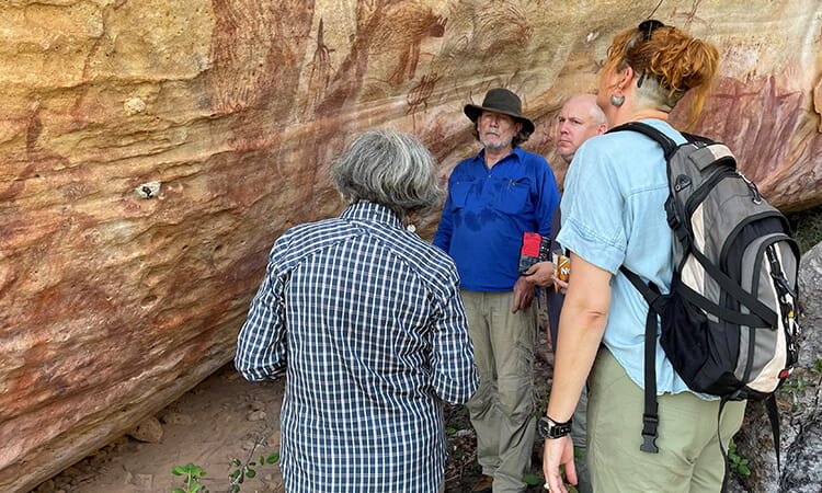 researchers inspecting aboriginal rock art