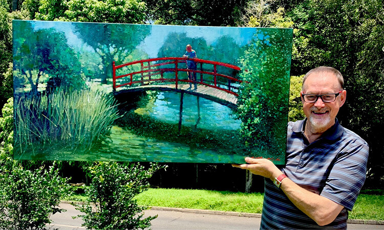 man in the garden with painting 