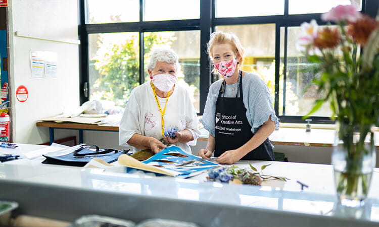 two women doing art