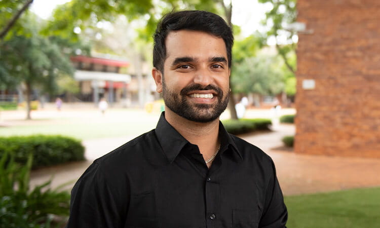 man smiling in the quad 