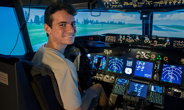 boy sitting in cockpit