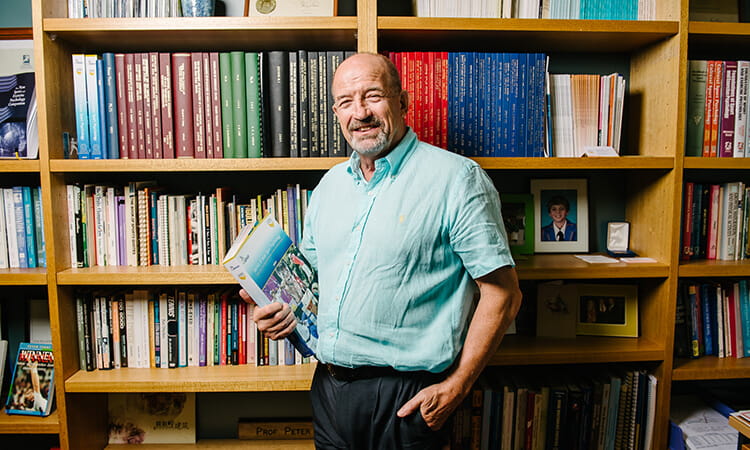 man in front of books