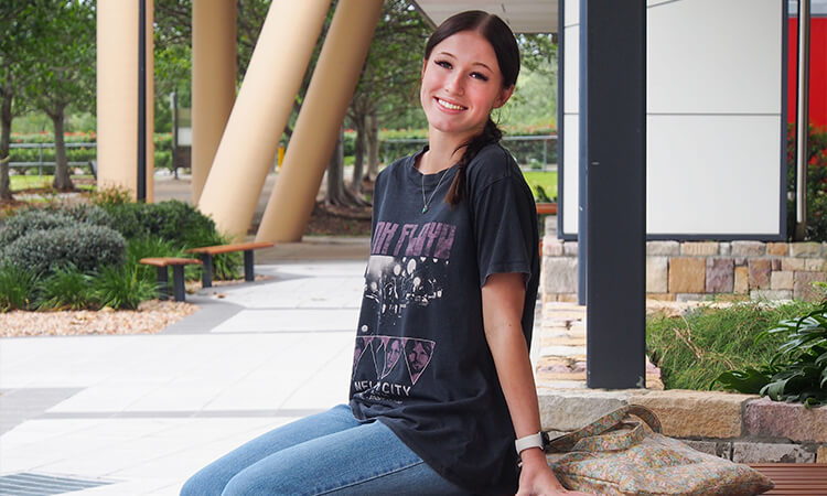 Student sitting on a bench.