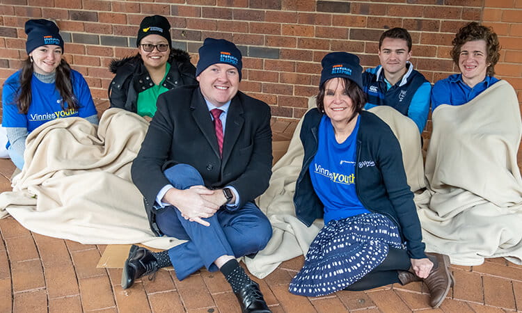 University of Southern Queensland Pro Vice-Chancellor (Engagement) Shawn Walker and St Vincent de Paul Society QLD Youth Engagement & Development Officer Julie Inskip are joined by Residential College students at the launch for the Vinnies Community Sleepout. 