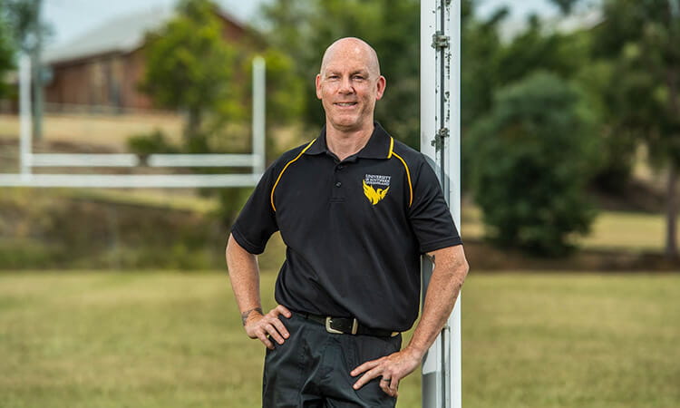 Man standing in football field.