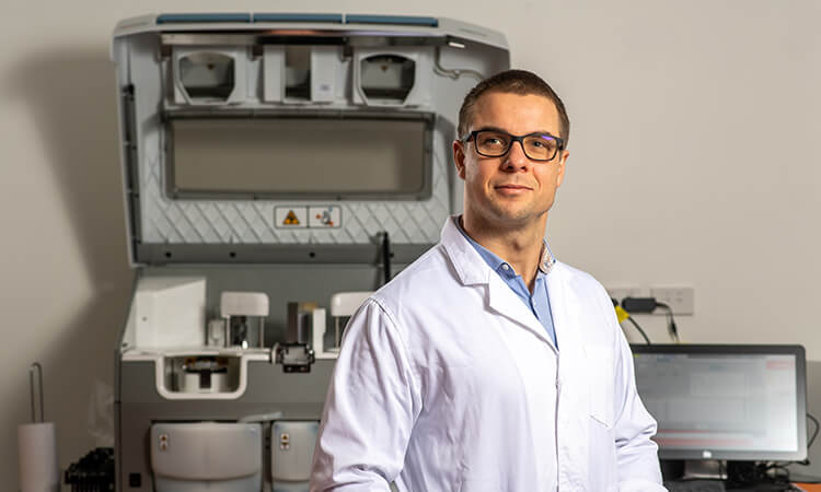 man in lab coat smiling