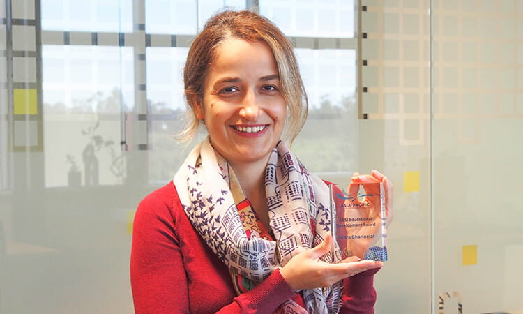 Woman holding award.