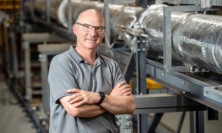 man smiling with his arms crossed