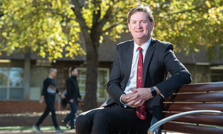 Professor Jim Nyland sitting on a chair.