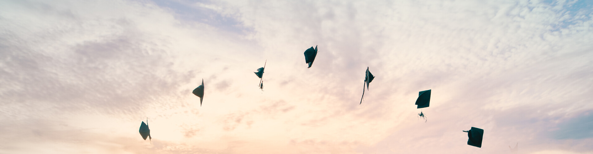 graduations caps thrown in the air 