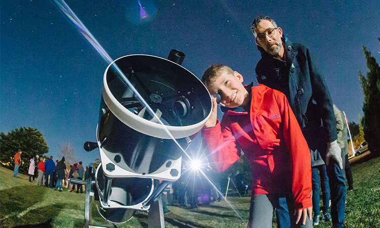 people looking through a telescope