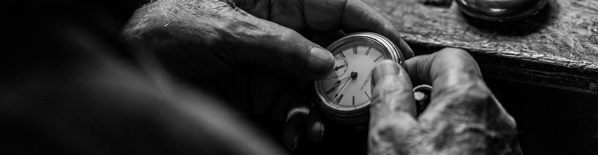 older persons hands holding a watch 