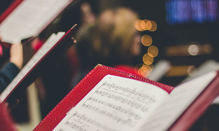 carolling by the christmas tree