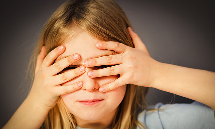 child covering their eyes 