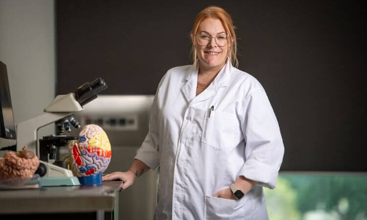 woman in lab coat smiling