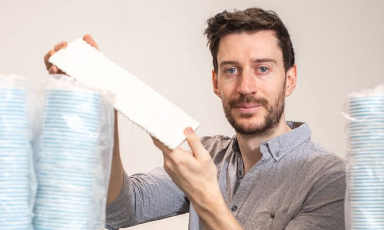 man with coffee cups