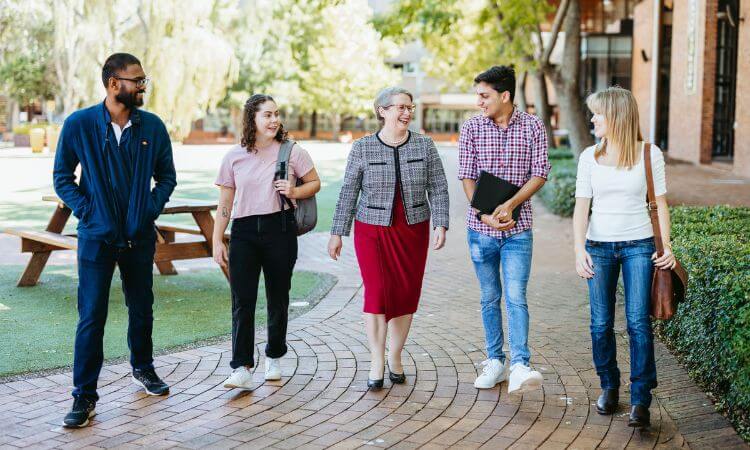 vice-chancellor walking with students