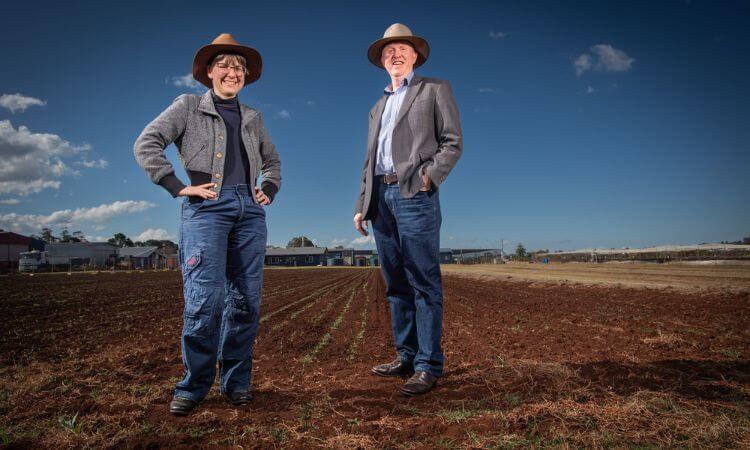 man and women stand in a field